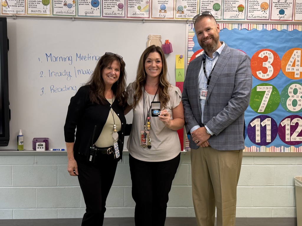 Image of Danielle posing with the Superintendent and Principal.