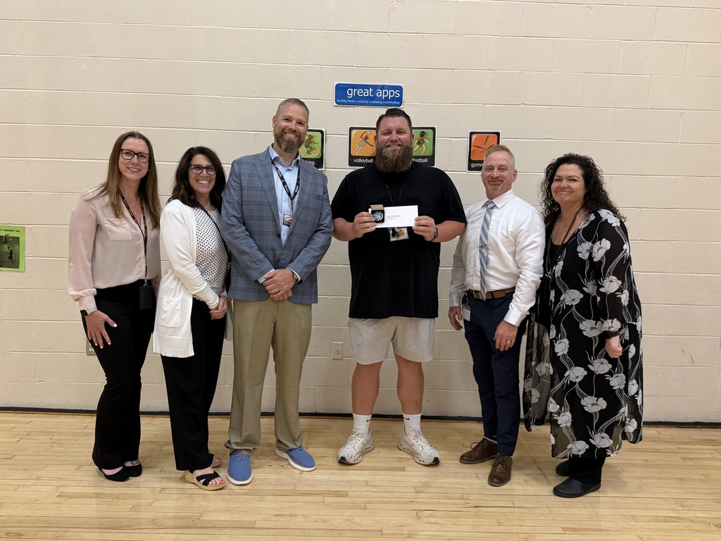 Image of Andrew posing with the Superintendent, district and building administrators.
