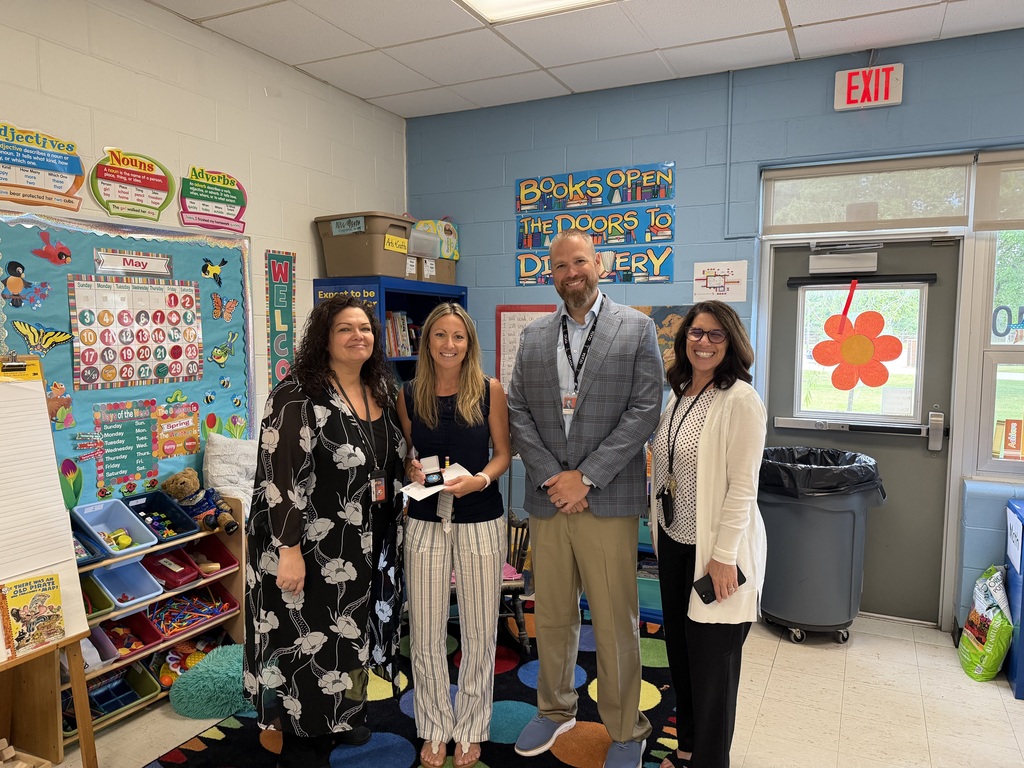 Image of Jaclyn posing with the Superintendent, Principal, and Supervisor.