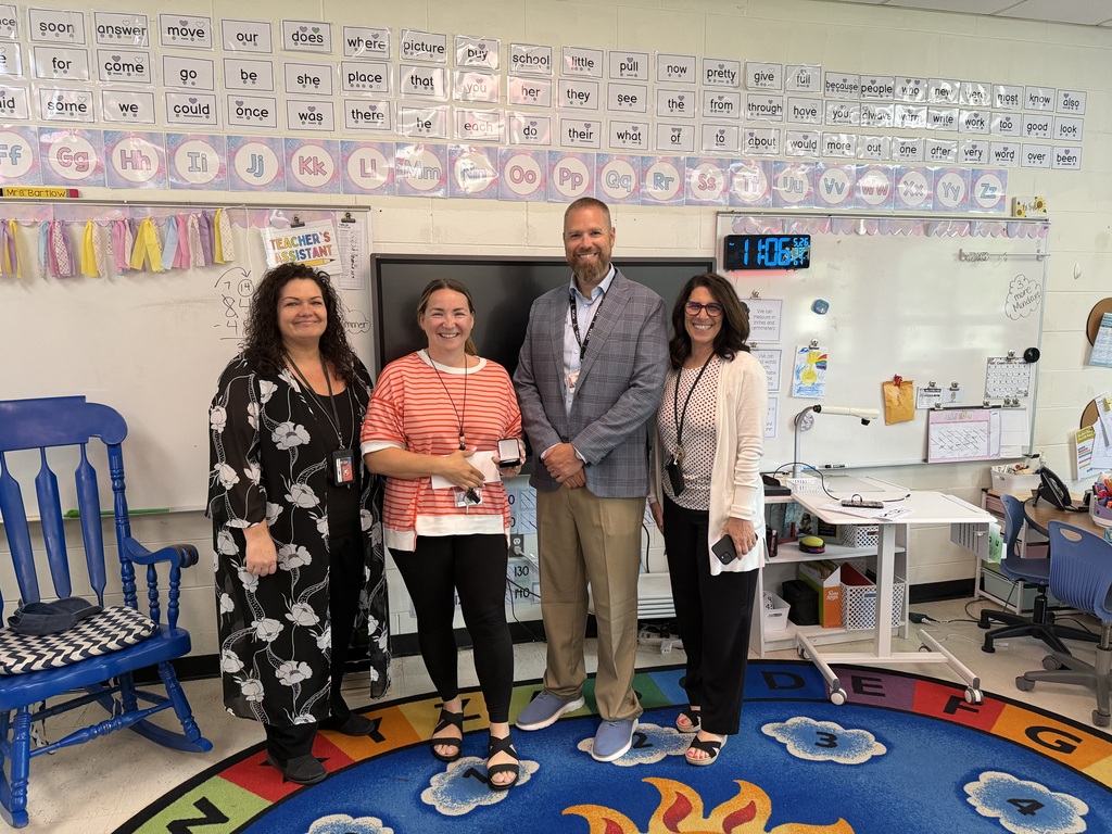 Image of Marissia posing with the Superintendent, Principal, and a Supervisor.
