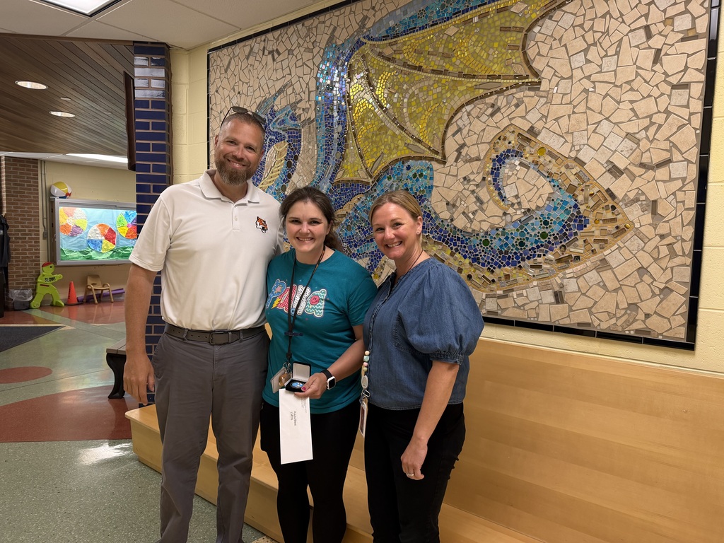 Image of Kayla posing with the Superintendent and Principal.