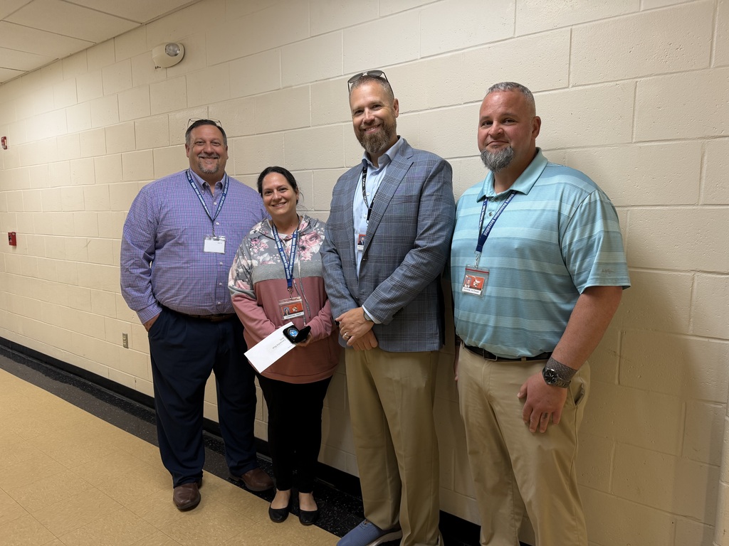 Image of Samantha posing with the Superintendent, Principal, and Vice Principal.