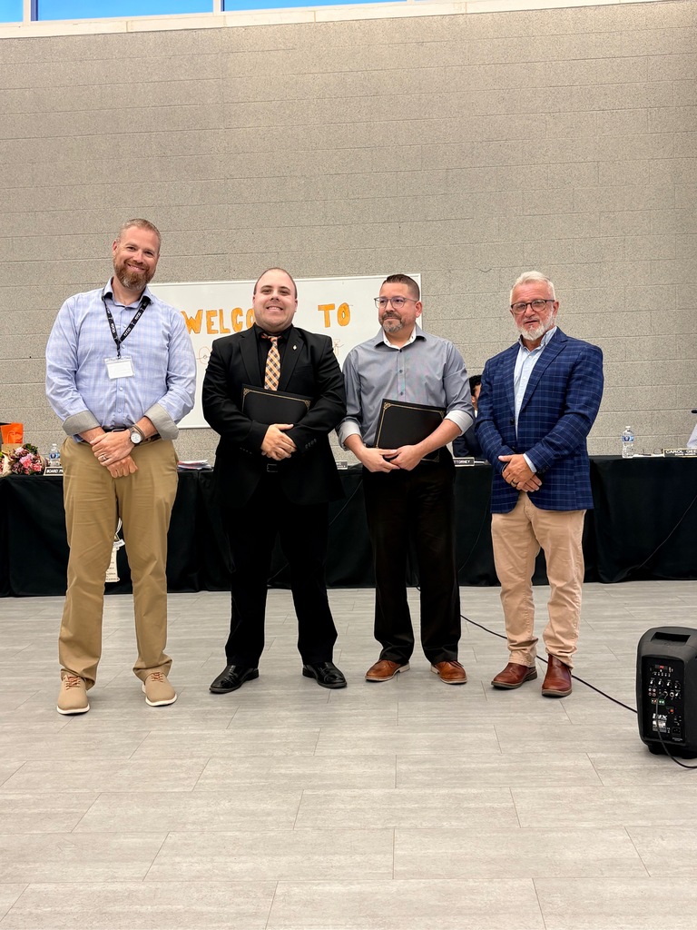 Image of Mr. McGrath and Mr. Salguero posing with the Superintendent and Board President. 
