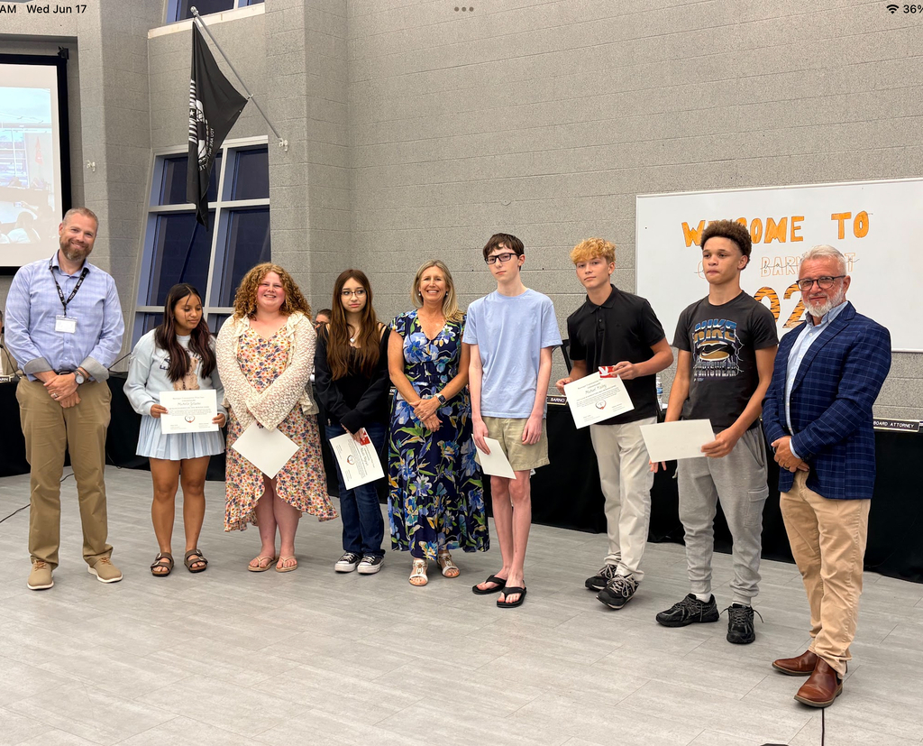 Image of six of the REAL media winners posing with the Superintendent, Board President, and Mrs. Germano.