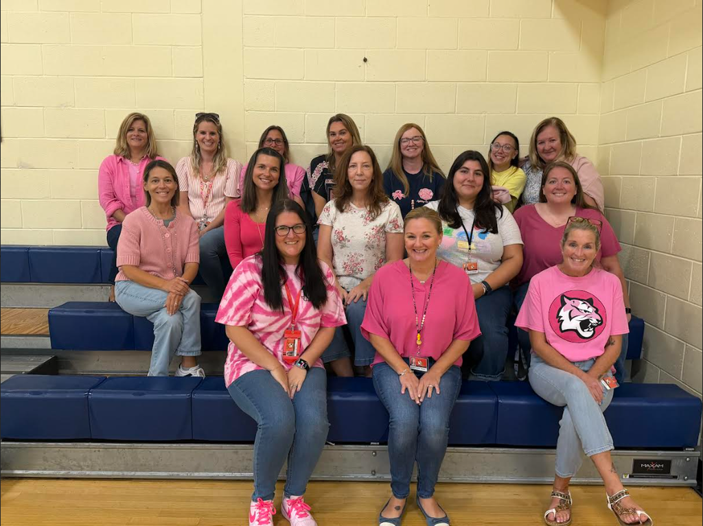 Group of teachers wearing Pink shirts and Denim for Breast Cancer Awareness