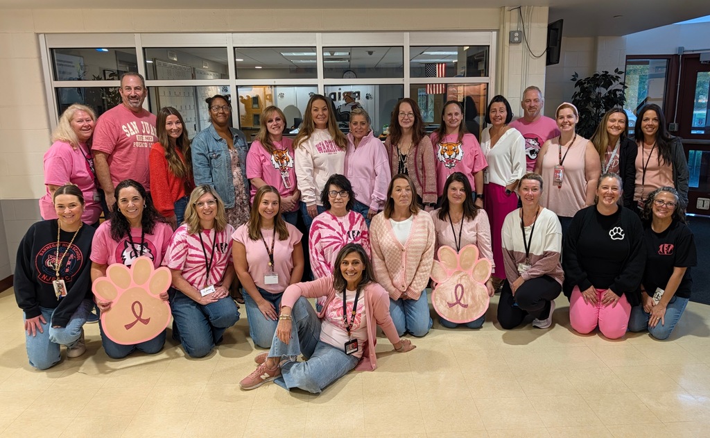 Group of teachers wearing Pink shirts and Denim for Breast Cancer Awareness