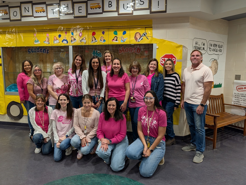 Group of teachers wearing Pink shirts and Denim for Breast Cancer Awareness