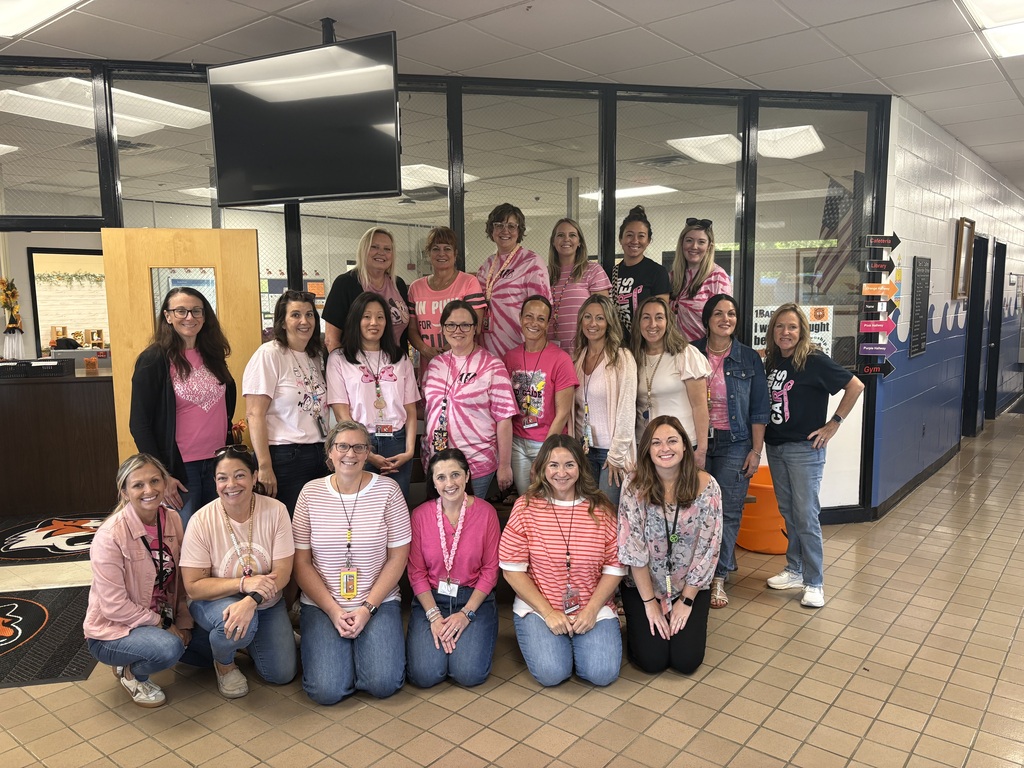 Group of teachers wearing Pink shirts and Denim for Breast Cancer Awareness