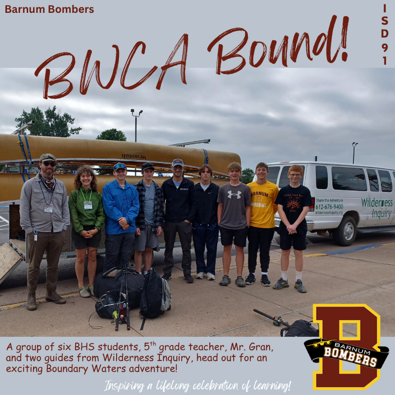 Group of 9 mixed ages standing in front of canoes before heading out to the BWCA