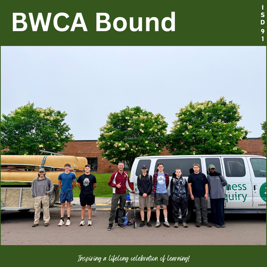 high school male students standing outside high school with a van pulling a trailer of canoes