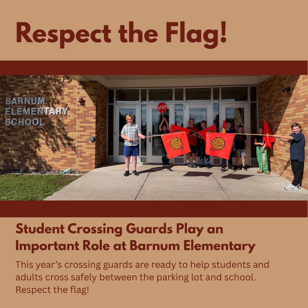 A group of elementary student crossing guards holding their orange stop flags in front of the school