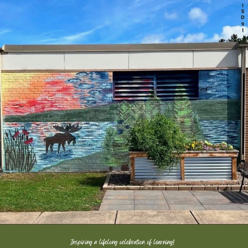 artwork of a lake with a moose in the water painted on the side of a building