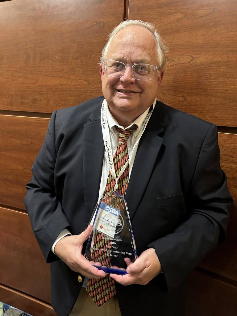 Jay Turner holding award