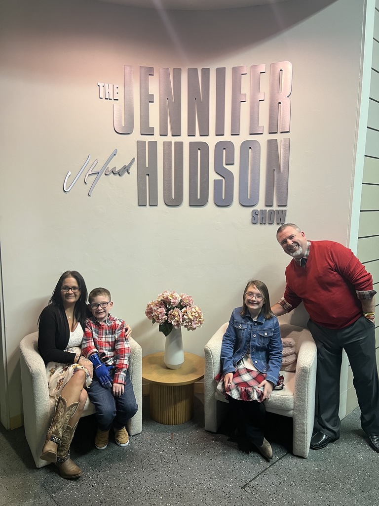The Farmer Family and Mr. Johnson in front of the show placard.