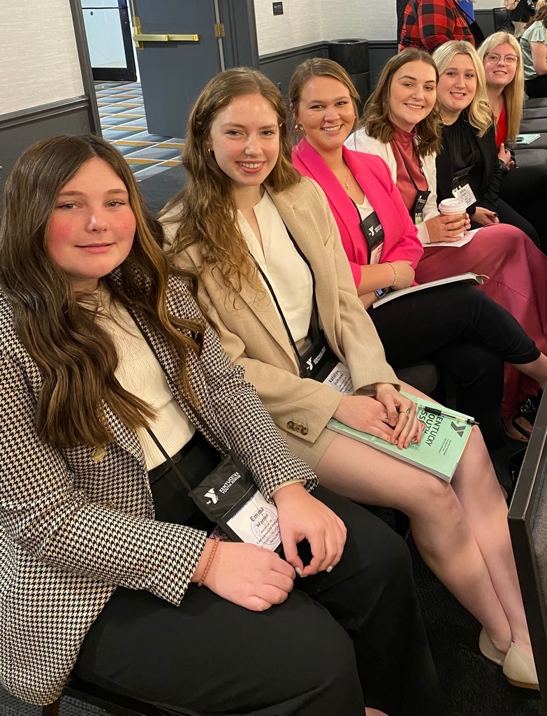 a group of students in blazers smiling