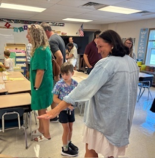 First Grade teacher Jess Garcia says hello to her new students and shows them their new classroom.