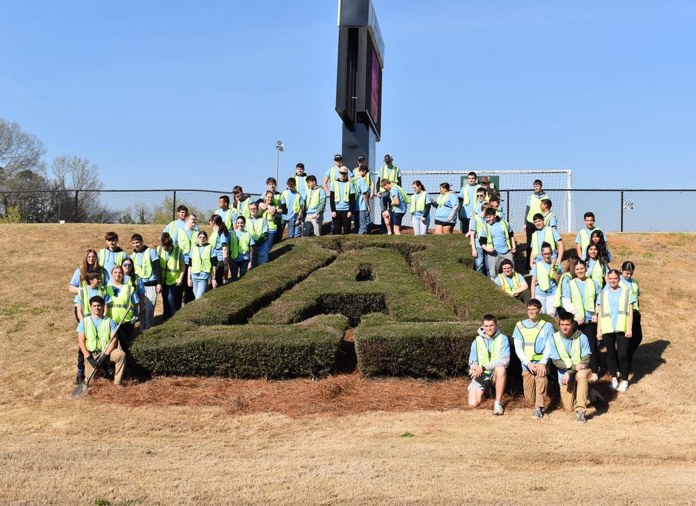 picture of JROTC cadets on campus cleanup day in the front of AHS