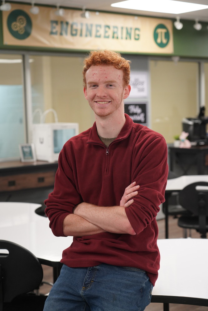 Jordon Goodwin sitting in an Engineering classroom with arms crossed