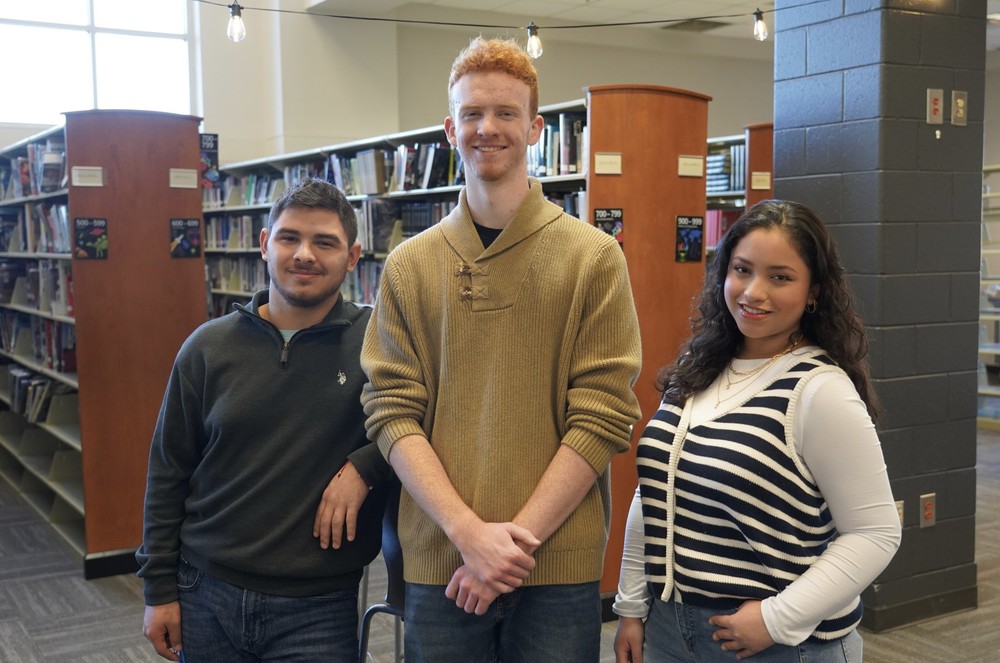 Adairsville high school students standing by bookcases in library
