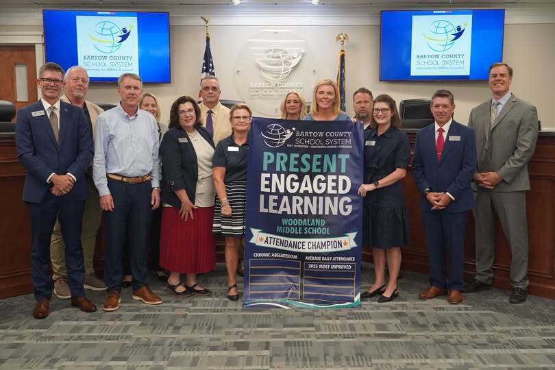 Picture of Leadership Team holding Award Banner