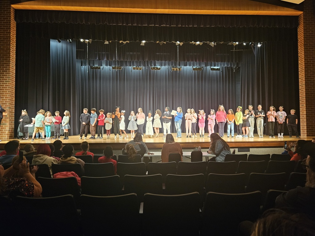 CLES talent show picture. Students that participating in the talent show are standing on the stage for a picture.
