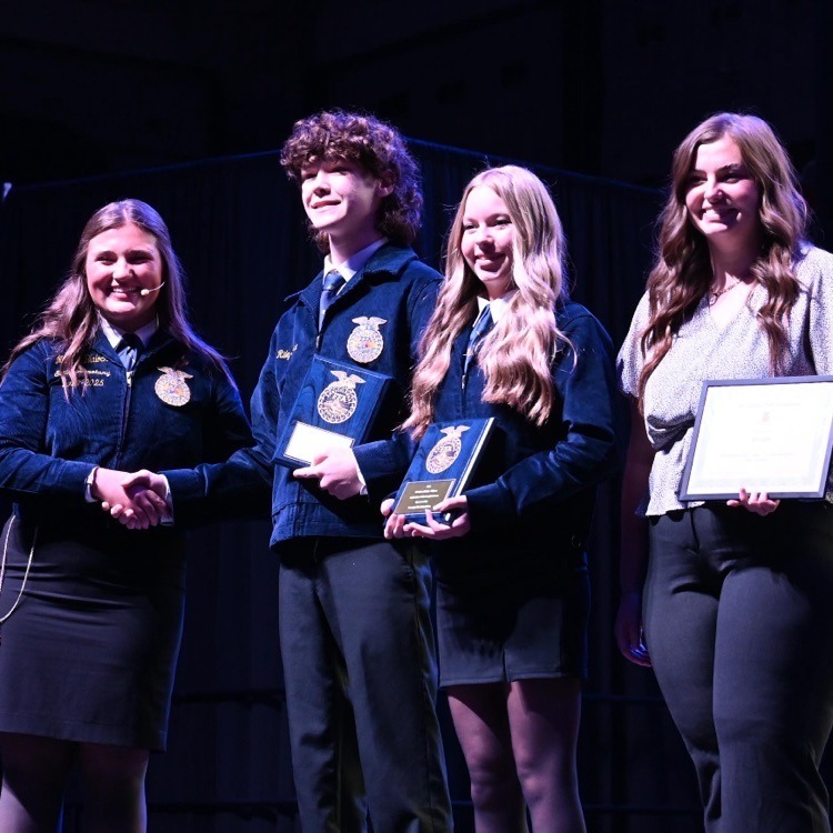 Adairsville High FFA students accepting an award on stage
