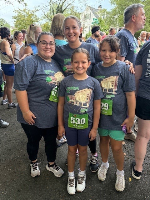 A group of staff smiling for a picture at the 5k