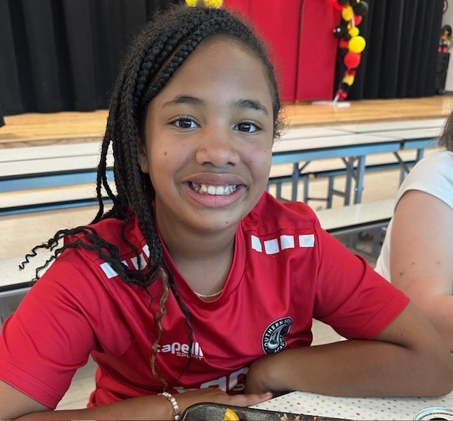 Student smiling for a picture on spirit day.