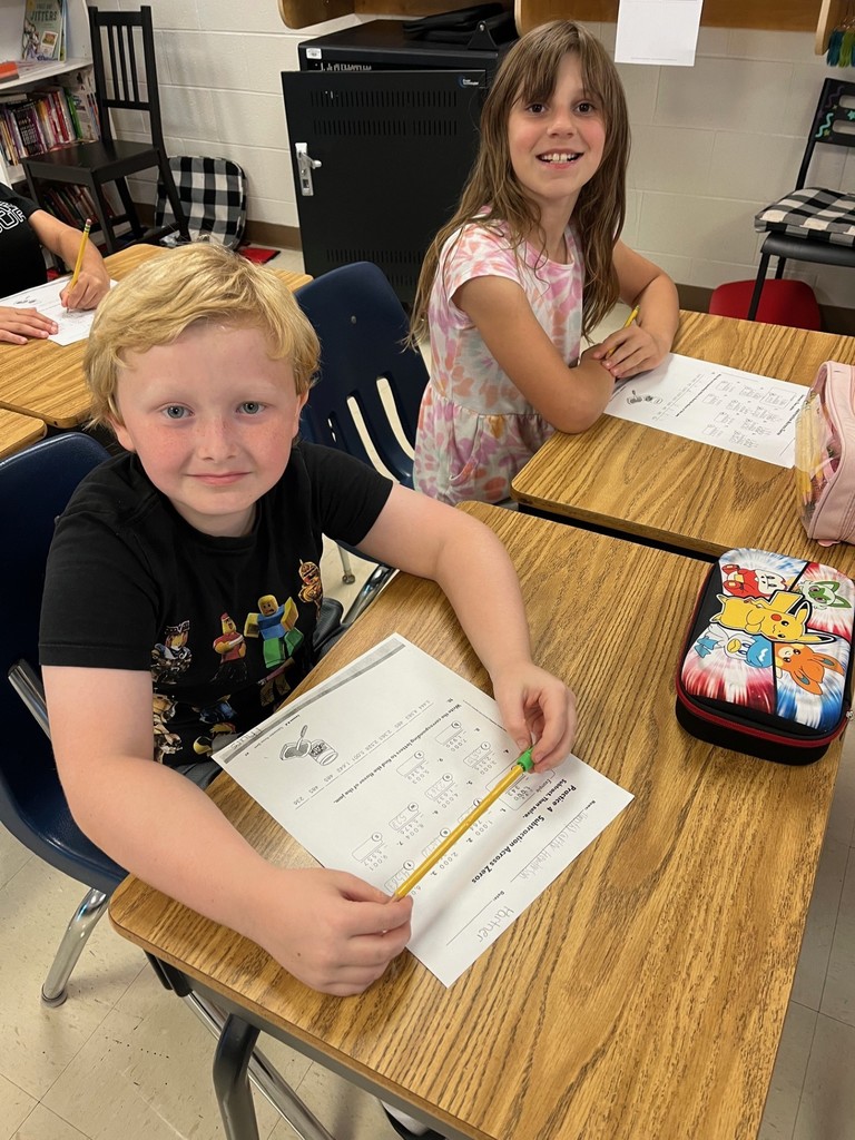 Students completing math problems.