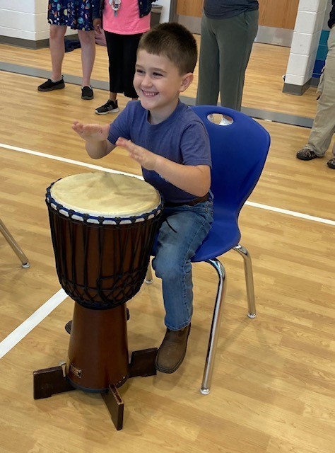 Student playing the drum.