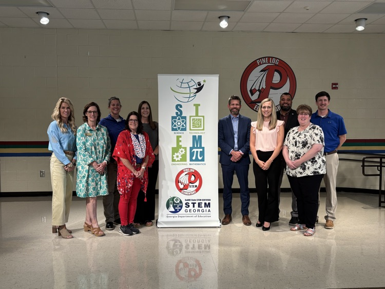 people standing with a STEM banner