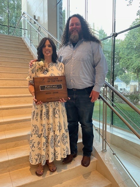 Our teacher of the year and her husband smiling for a picture at the Booth Museum.