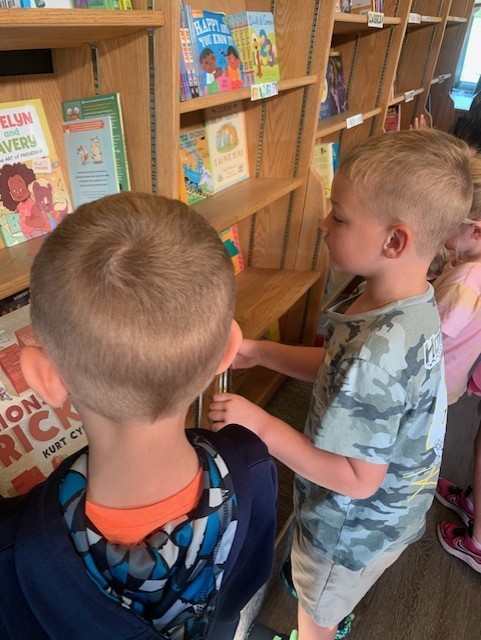 students looking at books in the book mobile