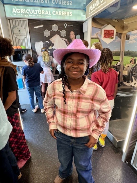 Our 3–5 students had an exciting visit from Georgia Farm Bureau and their mobile Georgia Ag Experience!  This 36-foot mobile classroom showcases Georgia agriculture on the road, visiting elementary schools and community organizations across the state. Inside, students explored seven different Georgia agricultural commodities through technology and digital learning.   The Georgia Ag Experience is a STEM-based program that invites students across Georgia to discover the vast opportunities in agriculture. It connects science, technology, and real-world farming in a way that brings learning to life for our students and helps them think about possible future careers in the agricultural field, from farming and animal science to technology and engineering.   A special shoutout to Gaines Beef for joining us with the Ag Mobile. They also partner with our School Nutrition team to provide fresh beef to our schools, and we are so grateful for their support.