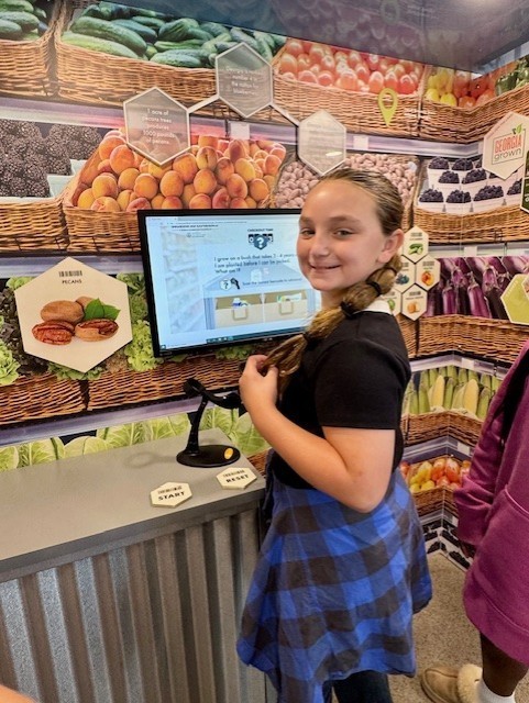 Our 3–5 students had an exciting visit from Georgia Farm Bureau and their mobile Georgia Ag Experience!  This 36-foot mobile classroom showcases Georgia agriculture on the road, visiting elementary schools and community organizations across the state. Inside, students explored seven different Georgia agricultural commodities through technology and digital learning.   The Georgia Ag Experience is a STEM-based program that invites students across Georgia to discover the vast opportunities in agriculture. It connects science, technology, and real-world farming in a way that brings learning to life for our students and helps them think about possible future careers in the agricultural field, from farming and animal science to technology and engineering.   A special shoutout to Gaines Beef for joining us with the Ag Mobile. They also partner with our School Nutrition team to provide fresh beef to our schools, and we are so grateful for their support.