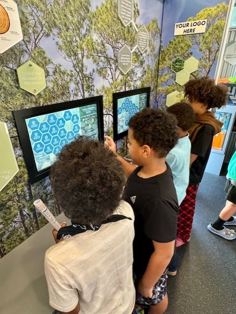 Our 3–5 students had an exciting visit from Georgia Farm Bureau and their mobile Georgia Ag Experience!  This 36-foot mobile classroom showcases Georgia agriculture on the road, visiting elementary schools and community organizations across the state. Inside, students explored seven different Georgia agricultural commodities through technology and digital learning.   The Georgia Ag Experience is a STEM-based program that invites students across Georgia to discover the vast opportunities in agriculture. It connects science, technology, and real-world farming in a way that brings learning to life for our students and helps them think about possible future careers in the agricultural field, from farming and animal science to technology and engineering.   A special shoutout to Gaines Beef for joining us with the Ag Mobile. They also partner with our School Nutrition team to provide fresh beef to our schools, and we are so grateful for their support.