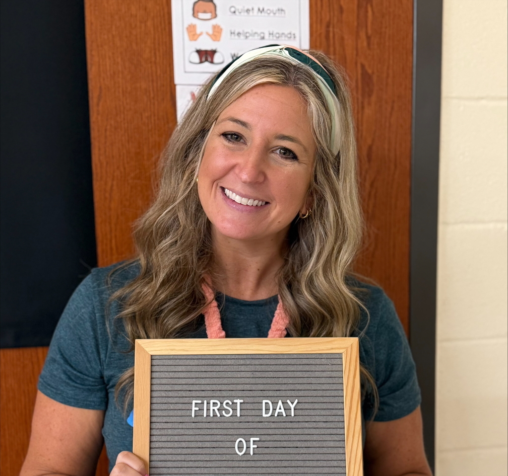 Ashley Mashburn, a teacher at Adairsville Elementary, holding a sign that says first day of.