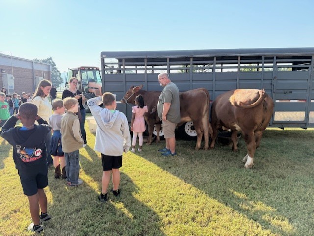 Thursday was full of Farm Fun for our K-2 graders!  All our littles got to experience life on a farm as they traveled around the school grounds visiting Georgia agricultural animals, thanks to our amazing local community partners who brought their own animals and equipment to our campus for us all to enjoy!  A big thank you to: Kevin and baby Blakeley from K&T Farms The Bagwell family Pettit Creek Farms The Joslin family Georgia Farm Bureau Bartow County Master Gardeners  Learning about agriculture and animals is important for our elementary students because it helps them understand where their food comes from, the hard work of local farmers, and the role agriculture plays in Georgia’s economy and community. It connects classroom learning to real-world experiences and inspires appreciation for the people who help feed us every day.  We enjoyed having a special guest, Sharon Viktora, BCSS Board Member, who visited our AG Mobile and Animal Encounter.  We appreciate everyone who made this such a memorable learning experience for our students! 