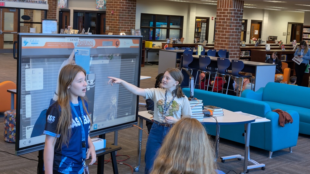 📚✨ Our 1st grade students wrapped up Module One of our new Tier 1 curriculum, Arts and Letters, with a very special “bookend” activity at Cass High School’s Media Center!  Students explored the joy of reading through fun, hands-on stations: 📖 Library & Read Aloud – Listening to The Book With No Pictures by BJ Novak 📚 Book Care – Learning how to take care of books and watching a Colibri machine in action 👥 Book Club – Meeting high school book club members, hearing about their love for reading, and playing “This or That – Reading Edition” 🎨 Bookmarks & Photo Booth – Creating their own bookmarks and taking fun group/solo photos 🖥️ Circulation Desk Tour – Guided by library interns with a special surprise along the way!  To finish the day, our students proudly took the “Reading Warrior” pledge and received a pin and certificate—reminders of the lifelong gift of books and the joy of reading at every age. 💛  We are so proud of our young readers and thankful to Cass High for hosting this memorable experience! 🌟📚
