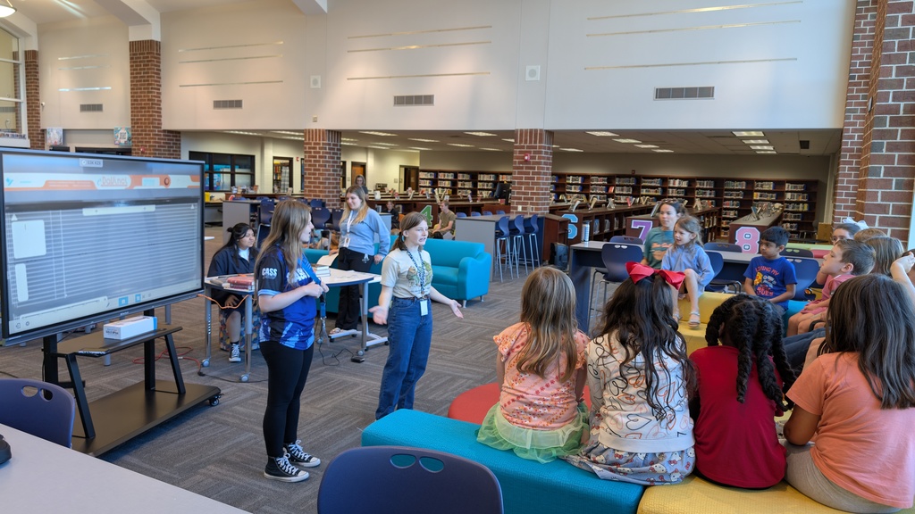 📚✨ Our 1st grade students wrapped up Module One of our new Tier 1 curriculum, Arts and Letters, with a very special “bookend” activity at Cass High School’s Media Center!  Students explored the joy of reading through fun, hands-on stations: 📖 Library & Read Aloud – Listening to The Book With No Pictures by BJ Novak 📚 Book Care – Learning how to take care of books and watching a Colibri machine in action 👥 Book Club – Meeting high school book club members, hearing about their love for reading, and playing “This or That – Reading Edition” 🎨 Bookmarks & Photo Booth – Creating their own bookmarks and taking fun group/solo photos 🖥️ Circulation Desk Tour – Guided by library interns with a special surprise along the way!  To finish the day, our students proudly took the “Reading Warrior” pledge and received a pin and certificate—reminders of the lifelong gift of books and the joy of reading at every age. 💛  We are so proud of our young readers and thankful to Cass High for hosting this memorable experience! 🌟📚