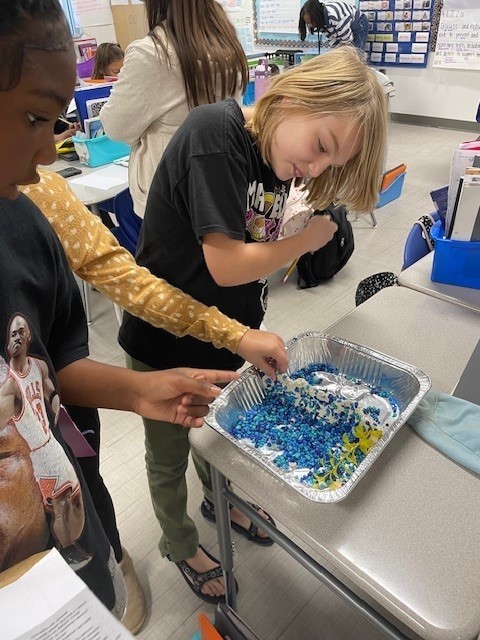 Students building a barrier for a flood during our STEM showcase.