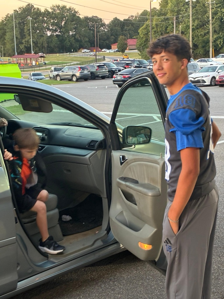 Cass High School Football players helping with car rider line this morning. 