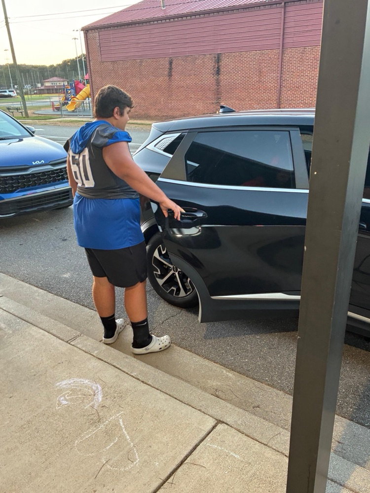 Cass High School Football players helping with car rider line this morning. 