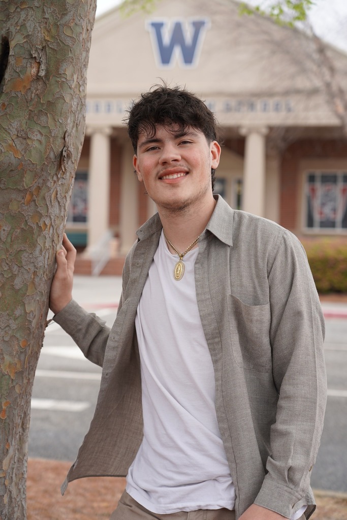 Makai Messier standing next to a tree