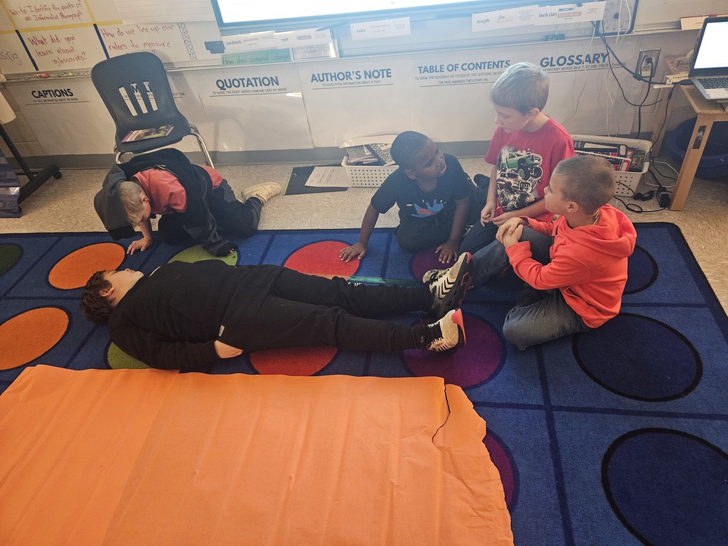 Mrs. Hill's 2nd grade had to "Build a bed" for a friend. They worked in groups on measuring a friend, measuring the paper given to them, and then making the bed the perfect size for their friend. 