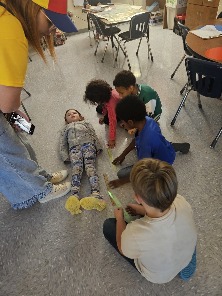 Mrs. Hill's 2nd grade had to "Build a bed" for a friend. They worked in groups on measuring a friend, measuring the paper given to them, and then making the bed the perfect size for their friend. 