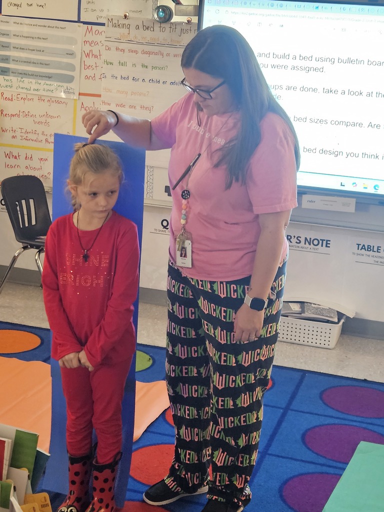 Mrs. Hill's 2nd grade had to "Build a bed" for a friend. They worked in groups on measuring a friend, measuring the paper given to them, and then making the bed the perfect size for their friend. 