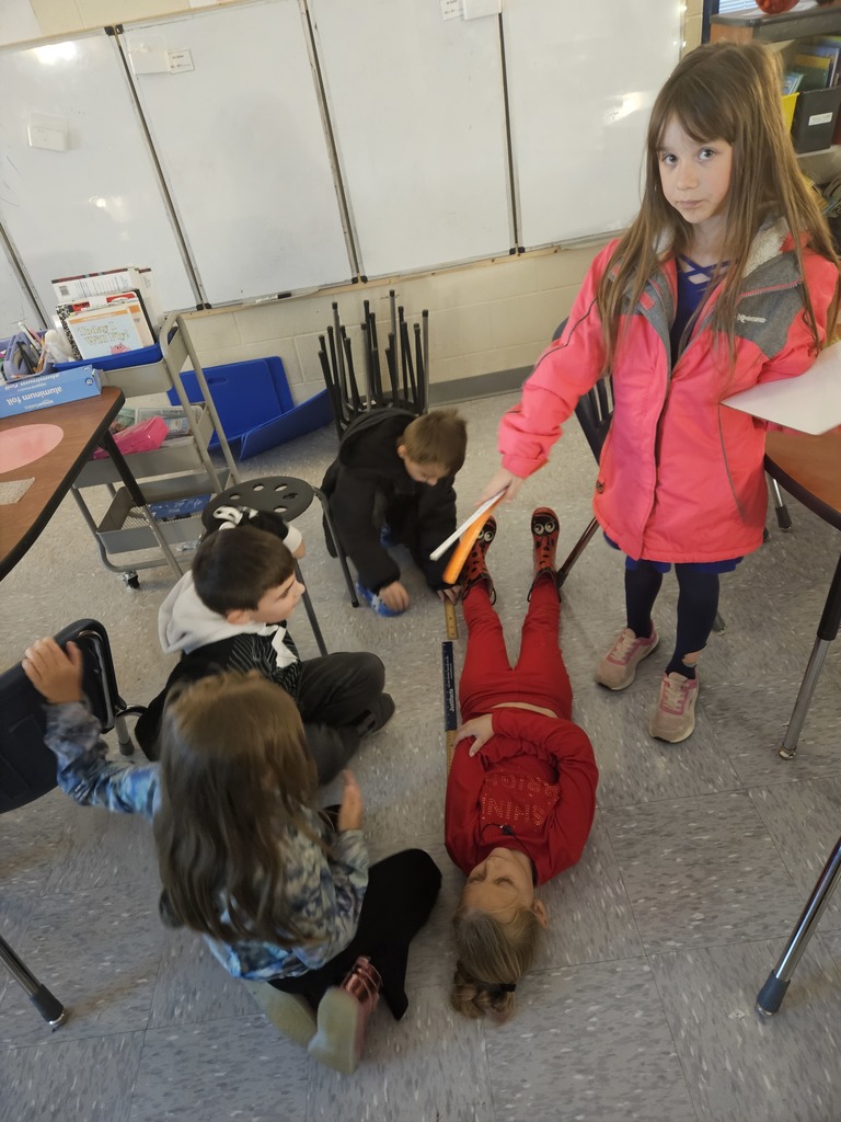 Mrs. Hill's 2nd grade had to "Build a bed" for a friend. They worked in groups on measuring a friend, measuring the paper given to them, and then making the bed the perfect size for their friend. 