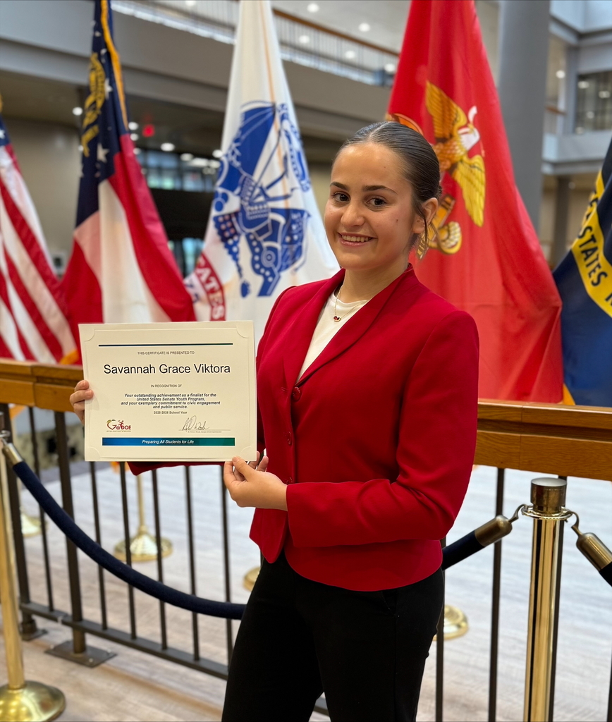 Savannah Viktora holding an award