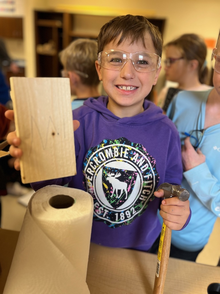 pine log student with hammer and wood